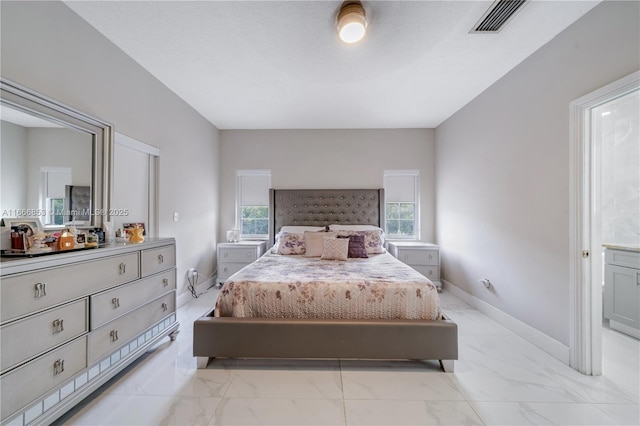 bedroom featuring marble finish floor, visible vents, and baseboards