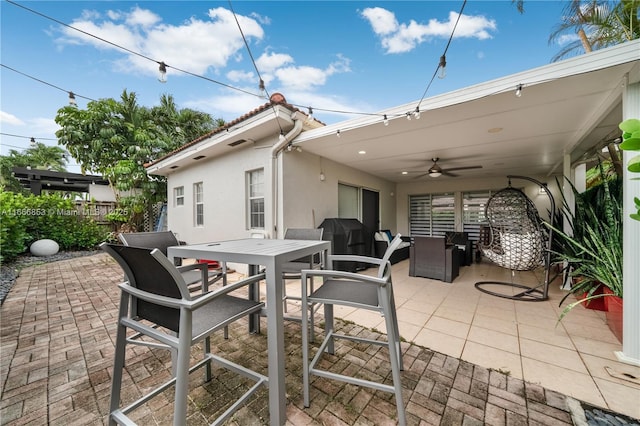 view of patio / terrace featuring a ceiling fan, outdoor dining space, and fence