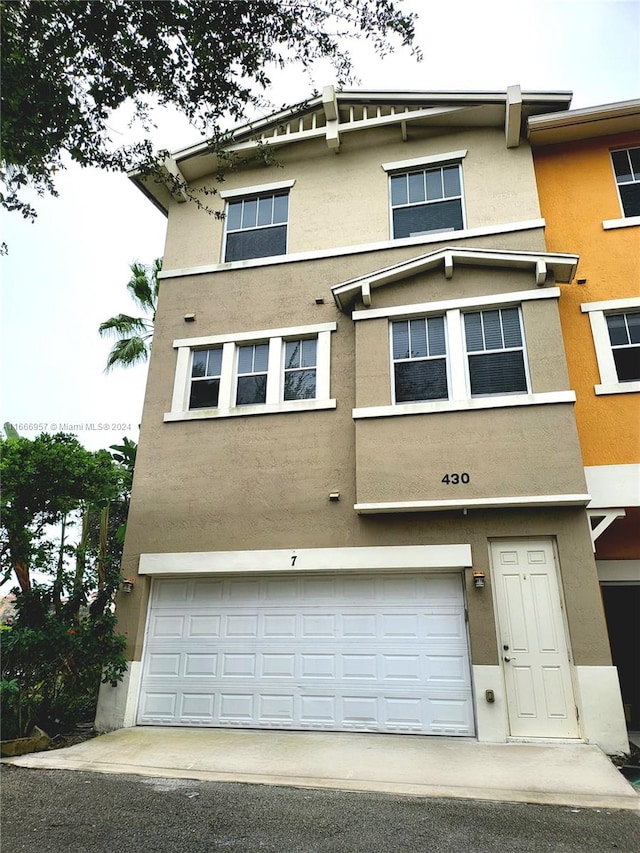 townhome / multi-family property featuring a garage