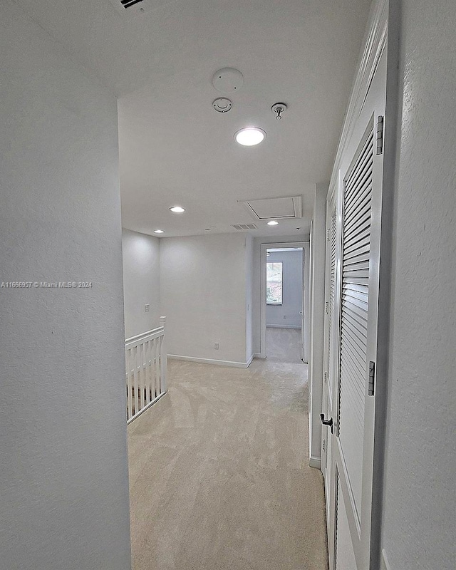 hallway with light carpet