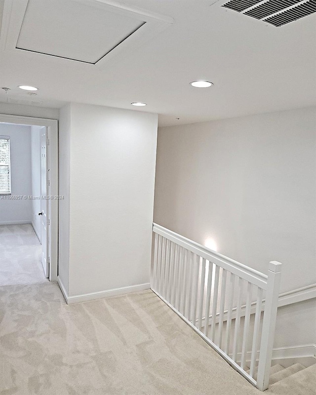 corridor with light colored carpet