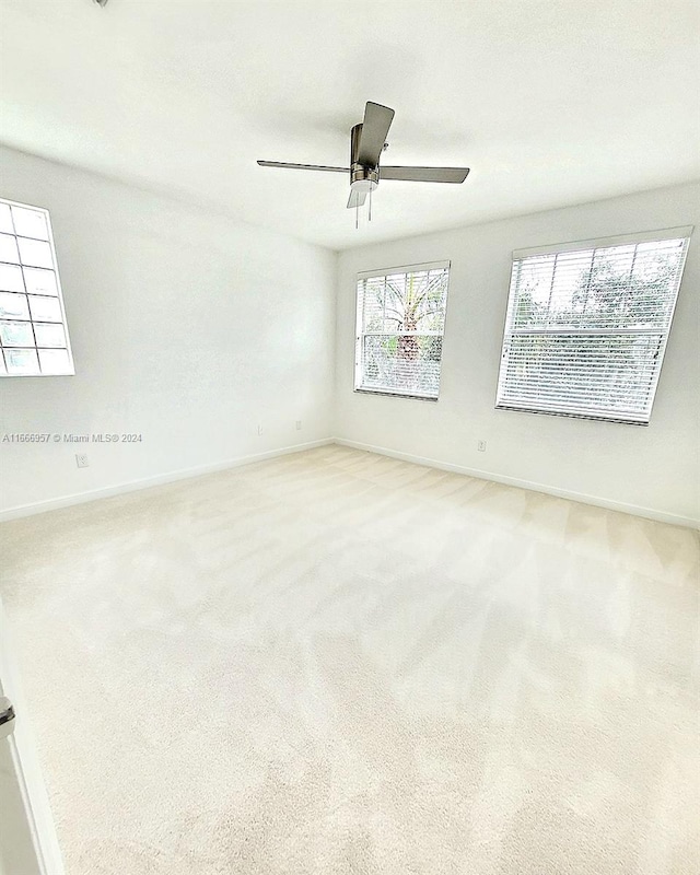 empty room with ceiling fan and carpet floors