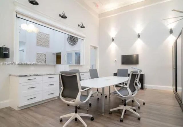 office area featuring light hardwood / wood-style flooring and a high ceiling