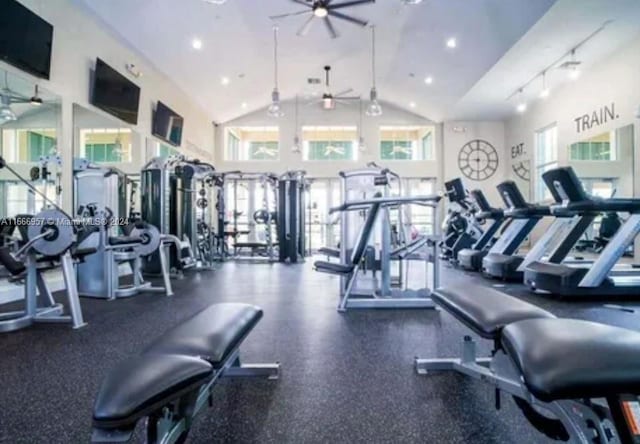 workout area with ceiling fan and high vaulted ceiling