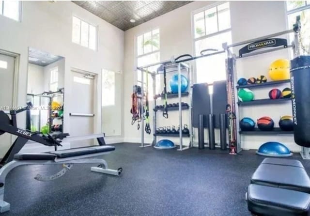 workout area with a high ceiling