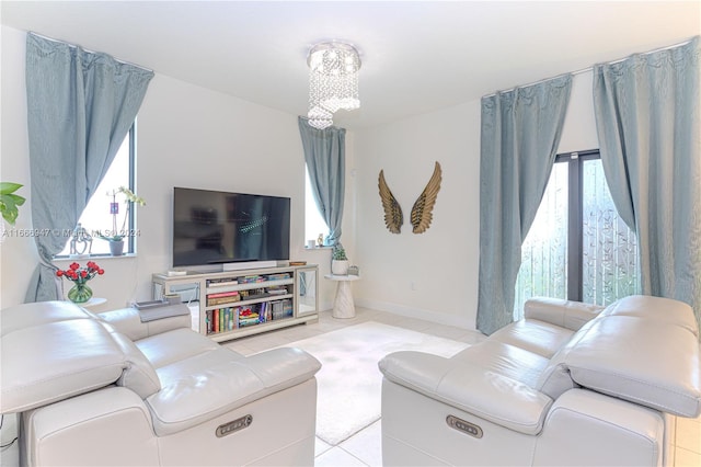 living room featuring light tile patterned flooring and a chandelier