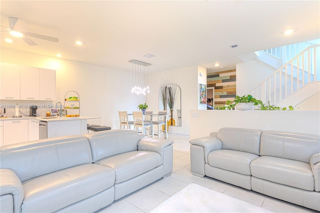 living room with sink, light tile patterned floors, and ceiling fan