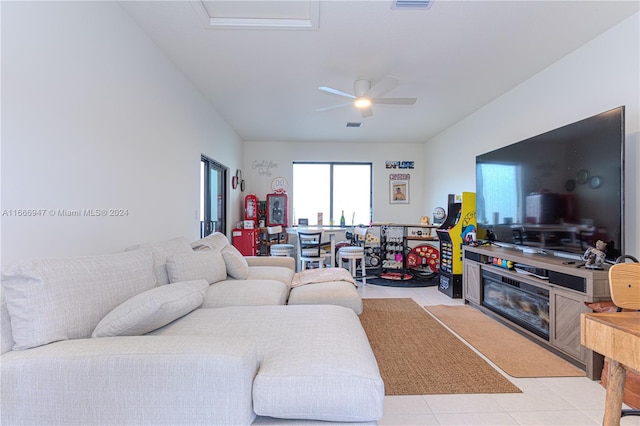 tiled living room with ceiling fan