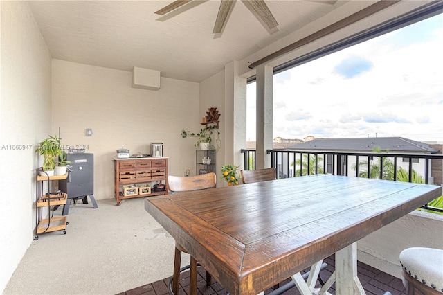 carpeted dining room featuring ceiling fan