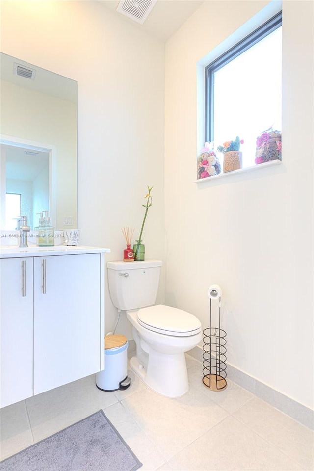 bathroom with vanity, toilet, and tile patterned floors