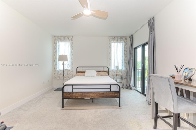 carpeted bedroom with multiple windows, access to exterior, and ceiling fan