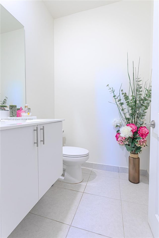 bathroom featuring vanity, toilet, and tile patterned floors