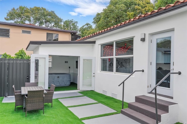 rear view of house featuring a yard and a patio area