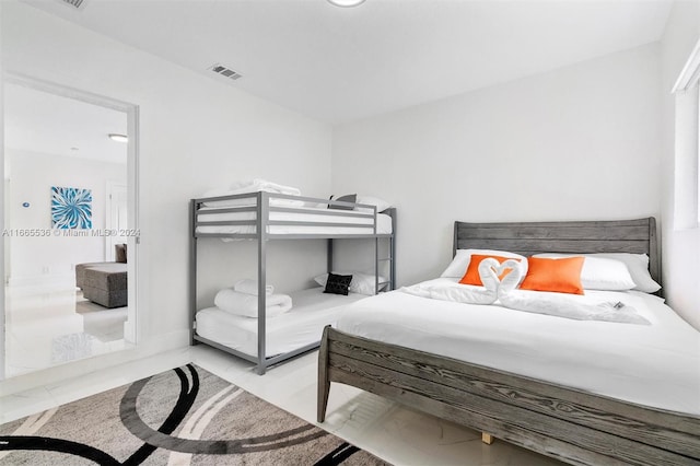 bedroom with light tile patterned floors