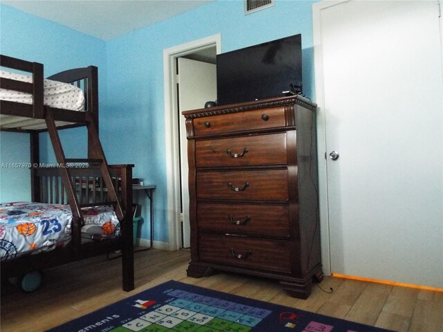 bedroom with wood-type flooring and ceiling fan