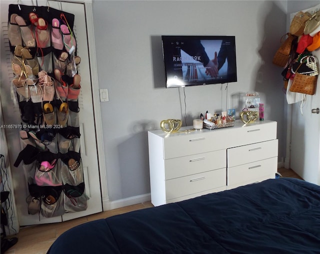 bedroom with a closet and light hardwood / wood-style floors