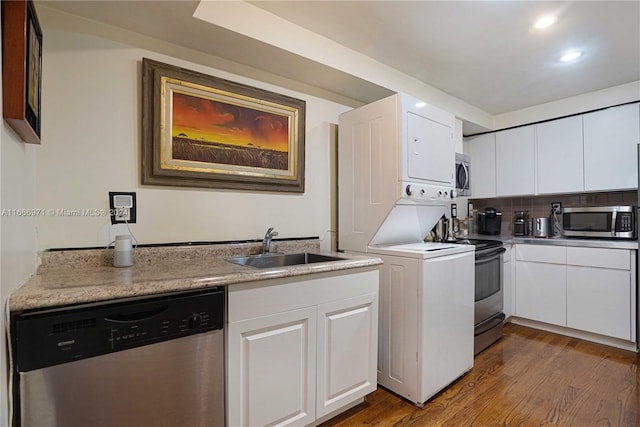 kitchen featuring white cabinetry, appliances with stainless steel finishes, dark hardwood / wood-style floors, and sink