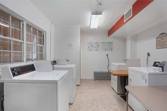 clothes washing area with washing machine and clothes dryer