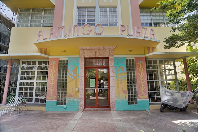 view of exterior entry with a balcony