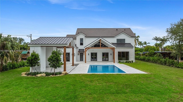 rear view of property featuring a yard and a patio area