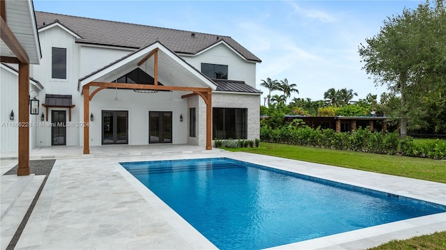 rear view of house with a yard and a patio