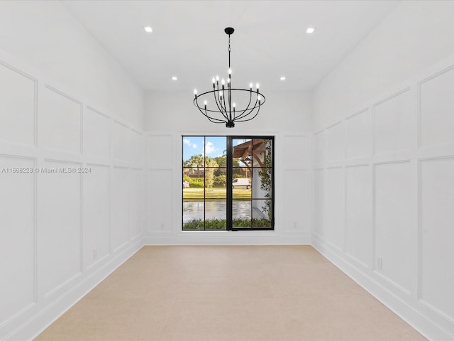 unfurnished room with a chandelier