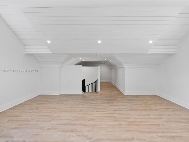 bonus room featuring wooden ceiling, vaulted ceiling, and light wood-type flooring