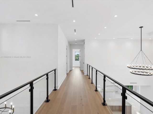 corridor with light hardwood / wood-style flooring