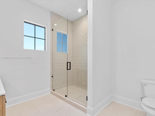 bathroom featuring an enclosed shower, vanity, and toilet