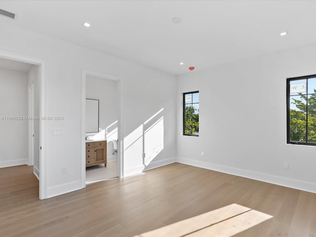 unfurnished room featuring a wealth of natural light and light hardwood / wood-style floors