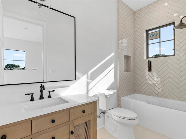 full bathroom featuring tiled shower / bath, vanity, toilet, and a healthy amount of sunlight