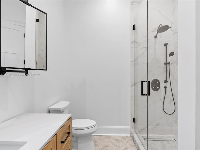 bathroom with an enclosed shower, vanity, and toilet