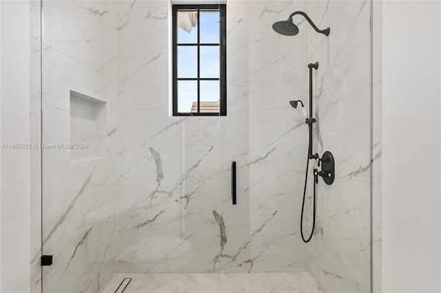 bathroom featuring a shower with shower door