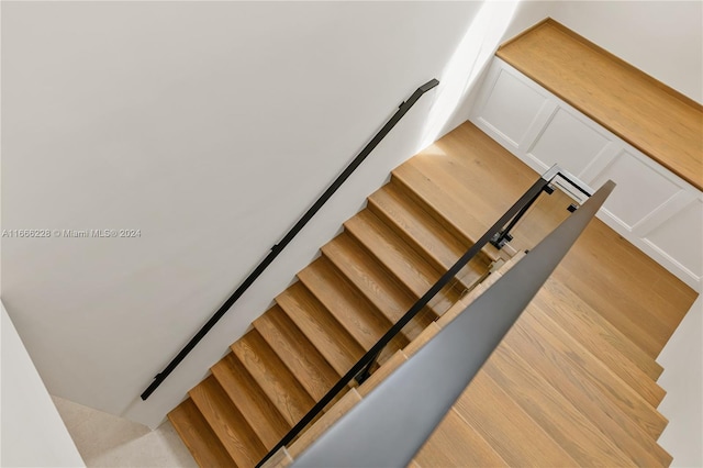 staircase with hardwood / wood-style flooring