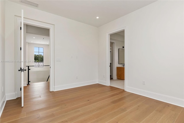 spare room featuring light hardwood / wood-style floors