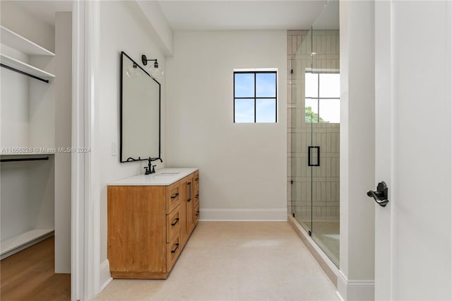 bathroom featuring an enclosed shower and vanity