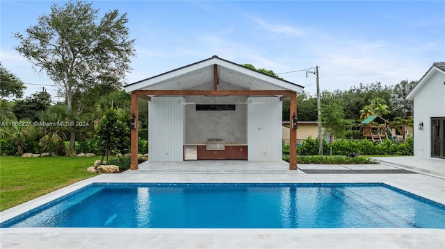 view of swimming pool featuring a grill, a yard, and a patio area