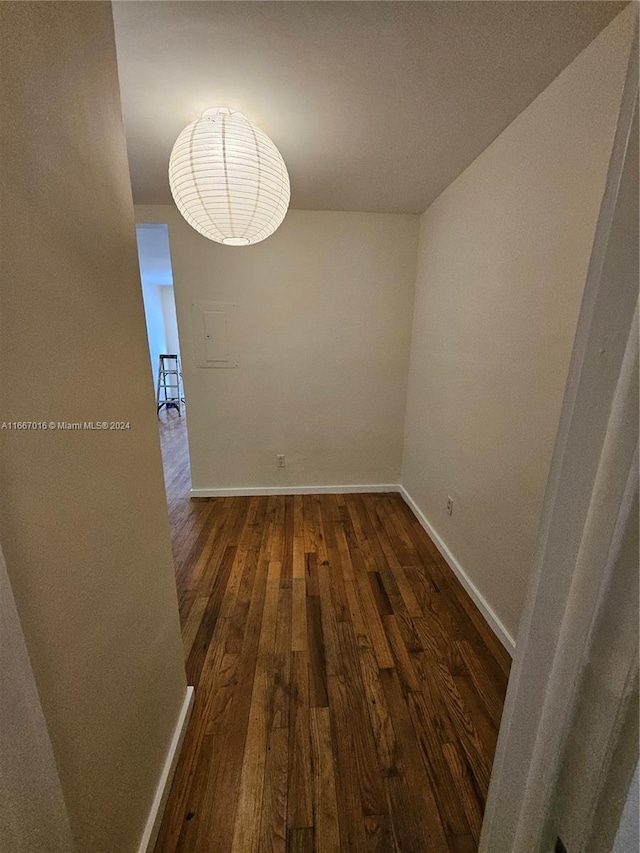 spare room with dark wood-type flooring