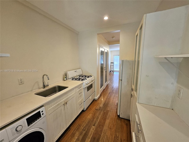 kitchen featuring dark hardwood / wood-style flooring, washer / clothes dryer, sink, and white appliances