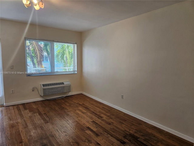 spare room with dark hardwood / wood-style floors and a wall mounted AC