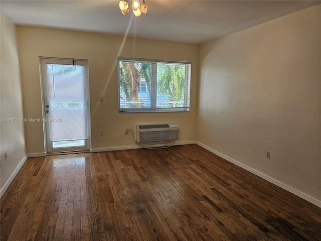 unfurnished dining area with an AC wall unit and dark wood-type flooring