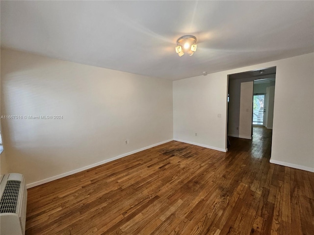 unfurnished room with dark hardwood / wood-style floors