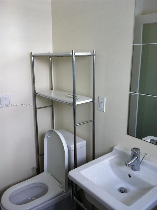 bathroom featuring sink and toilet