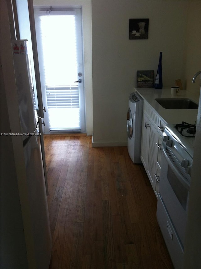 kitchen with white cabinets, sink, electric range, and a healthy amount of sunlight