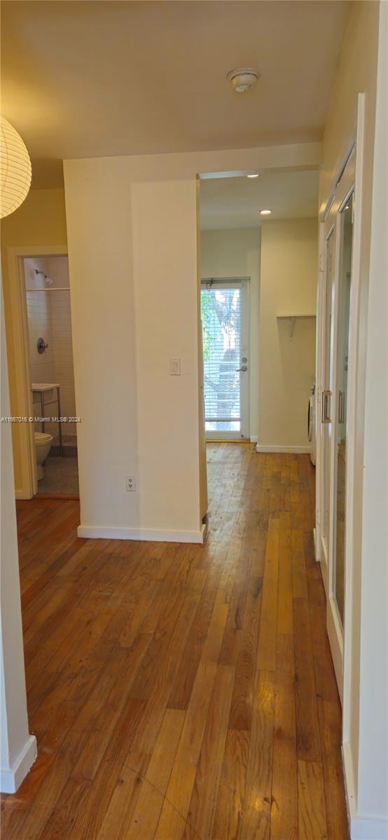 hall with hardwood / wood-style flooring