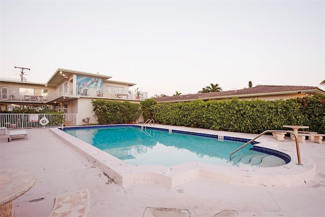 view of swimming pool with a patio area