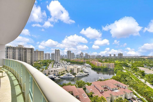 balcony featuring a city view and a water view