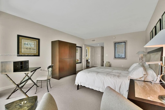 bedroom featuring visible vents and light carpet