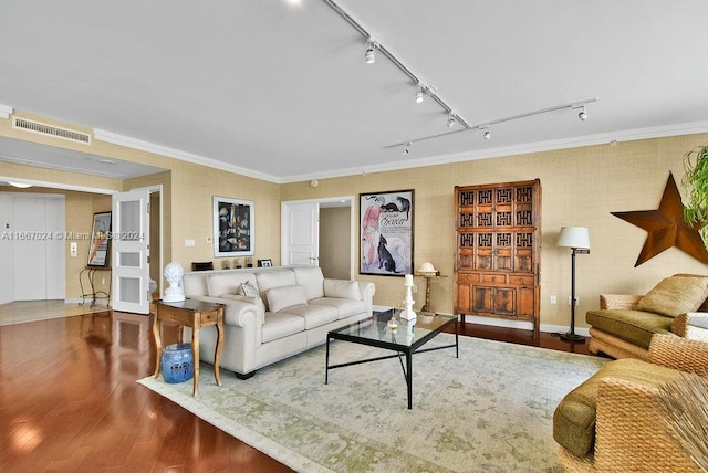 living room with rail lighting, ornamental molding, and hardwood / wood-style floors