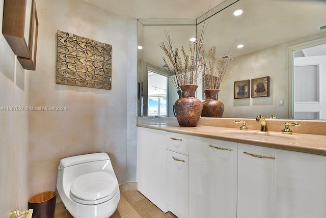 bathroom featuring visible vents, vanity, recessed lighting, and toilet